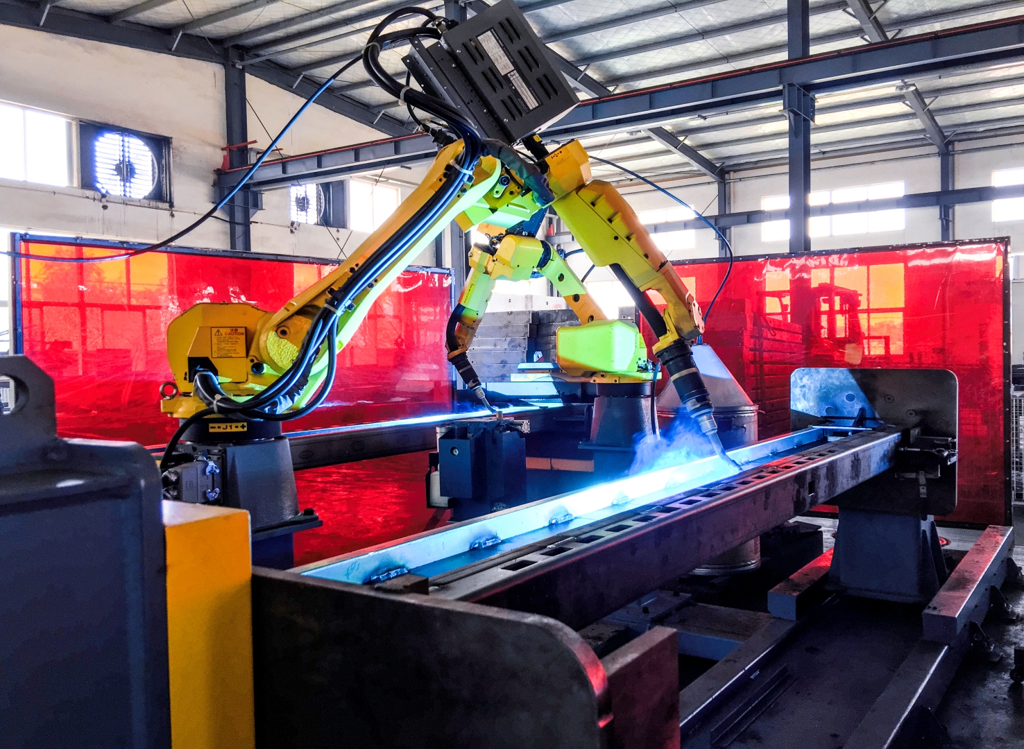 Robotic welding of structural steel frames for parking lifts under a controlled welding specification